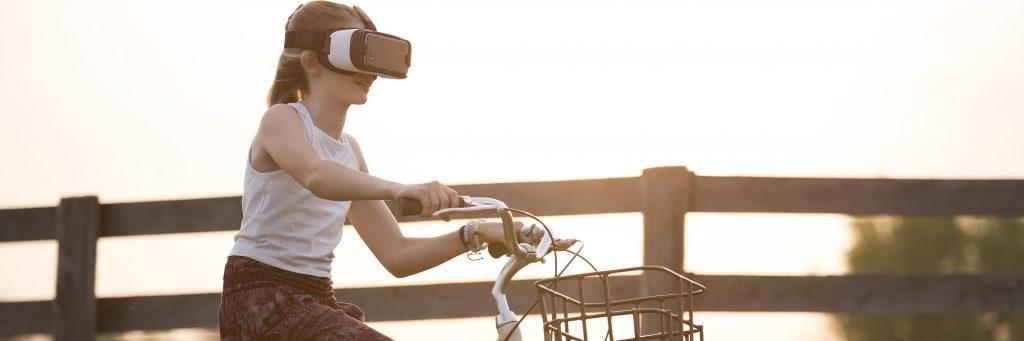 Woman rides a bike wearing a virtual reality headset